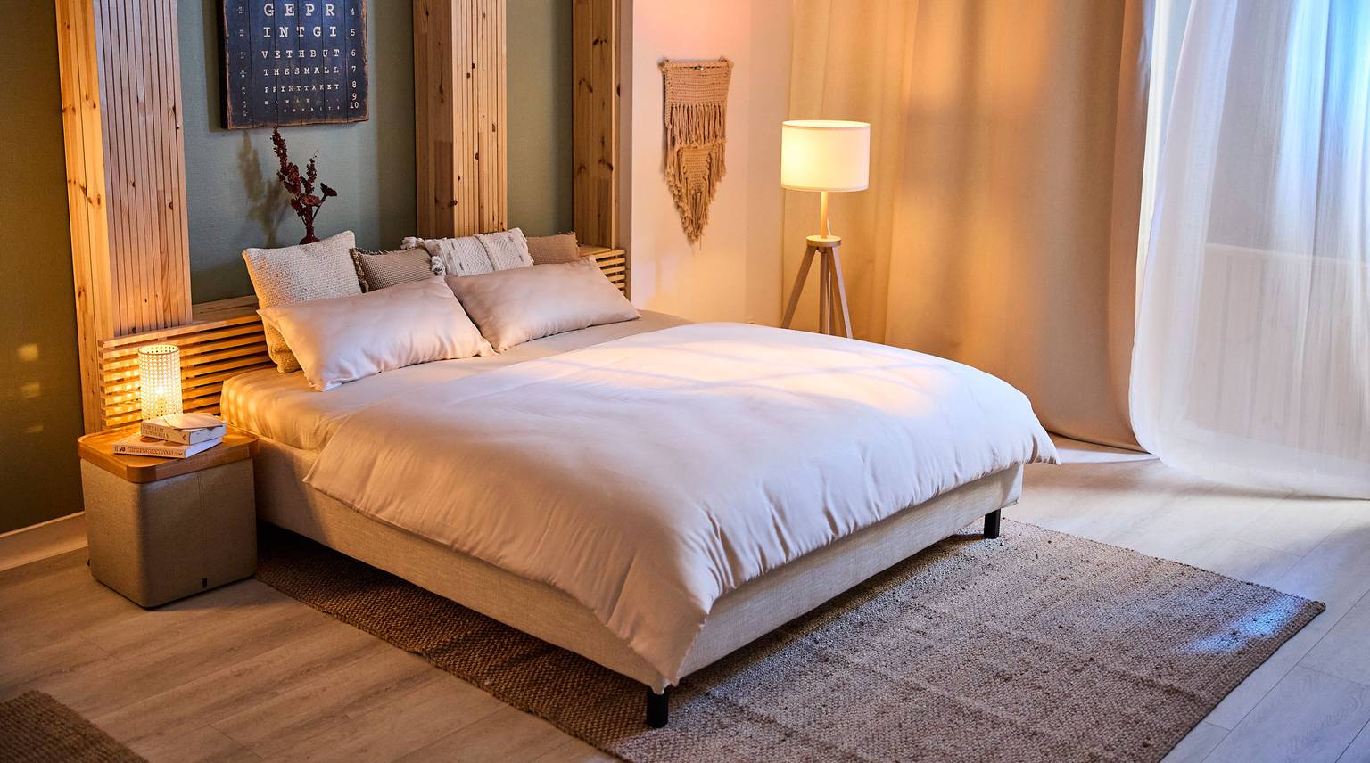 Cozy bedroom with a bed, pillows, and a duvet in warm tones.