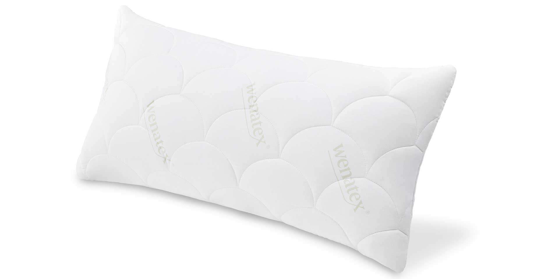 Kissen mit einer weißen, strukturierten Oberfläche in ovalem Muster auf hellem Hintergrund.