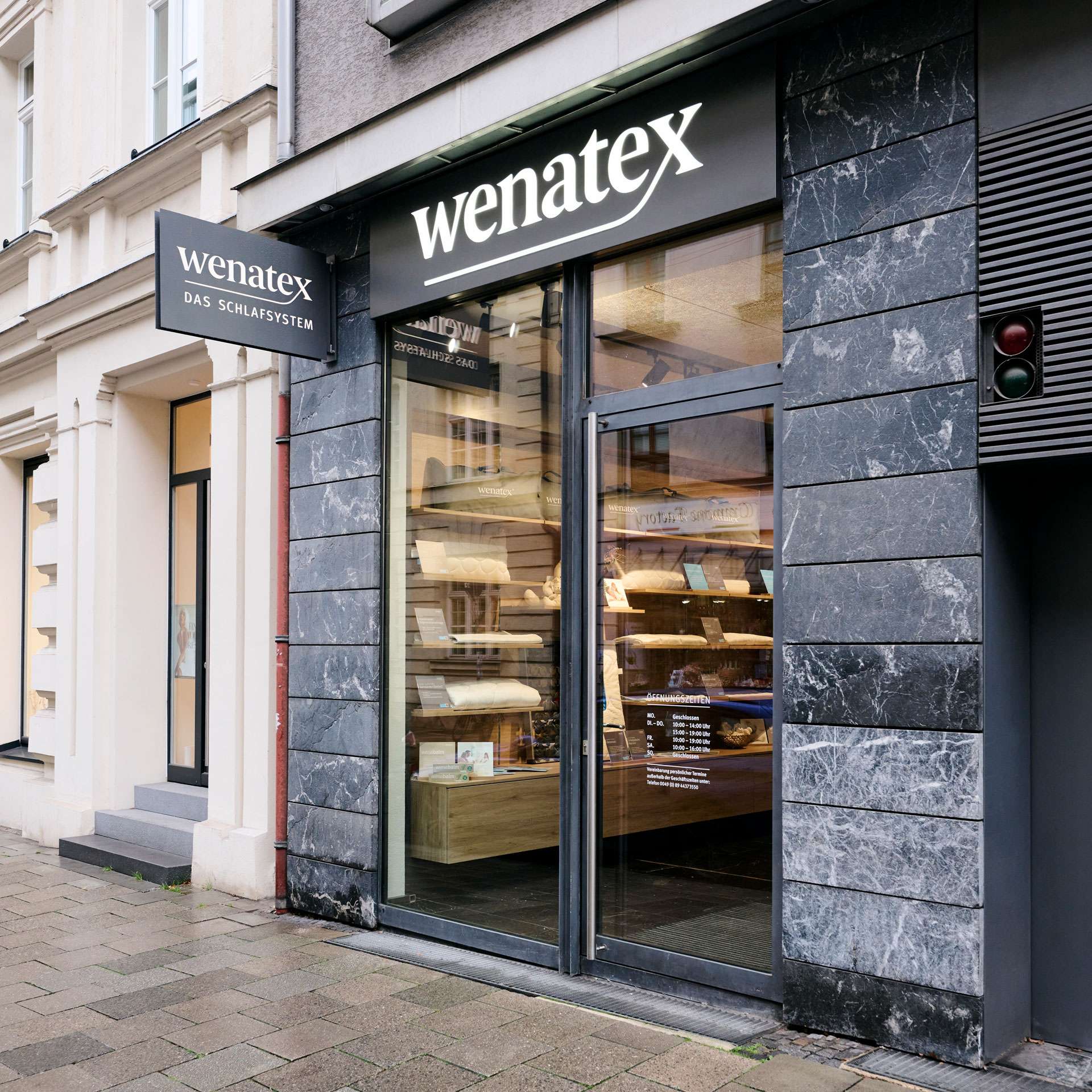 Exterior view of a store with large windows and a modern entrance area.